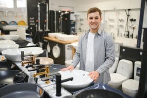 Man choosing a batgh sink with sales person.