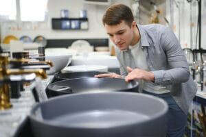 Man at the building market looking for sink into their bathroom.