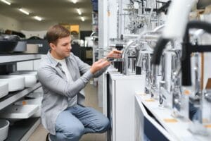 Man chooses a products in a sanitary ware store.