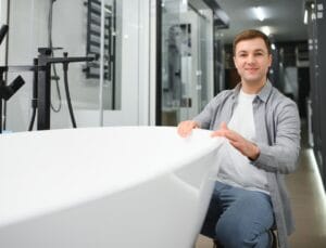 Young man choosing a bath and bath sink.